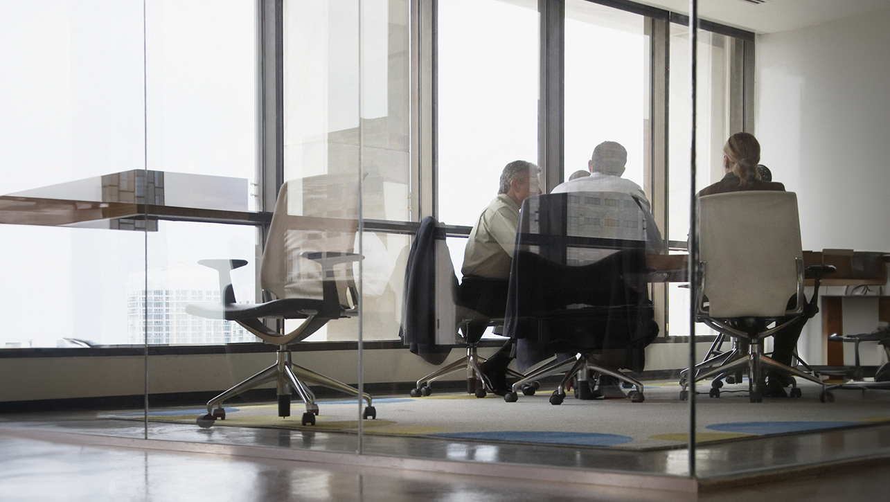 Three businesspeople in boardroom